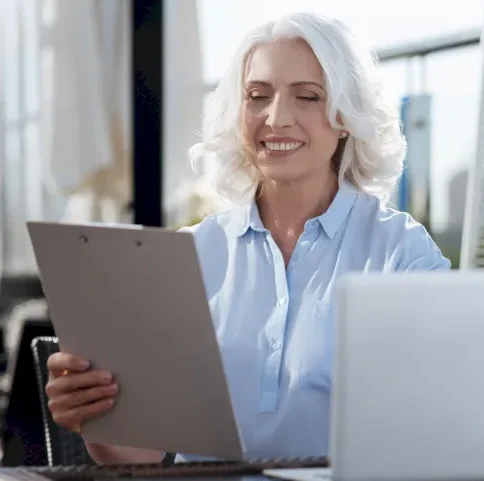 positive-delighted-female-person-keeping-smile-her-face-looking-forward-while-reading-something